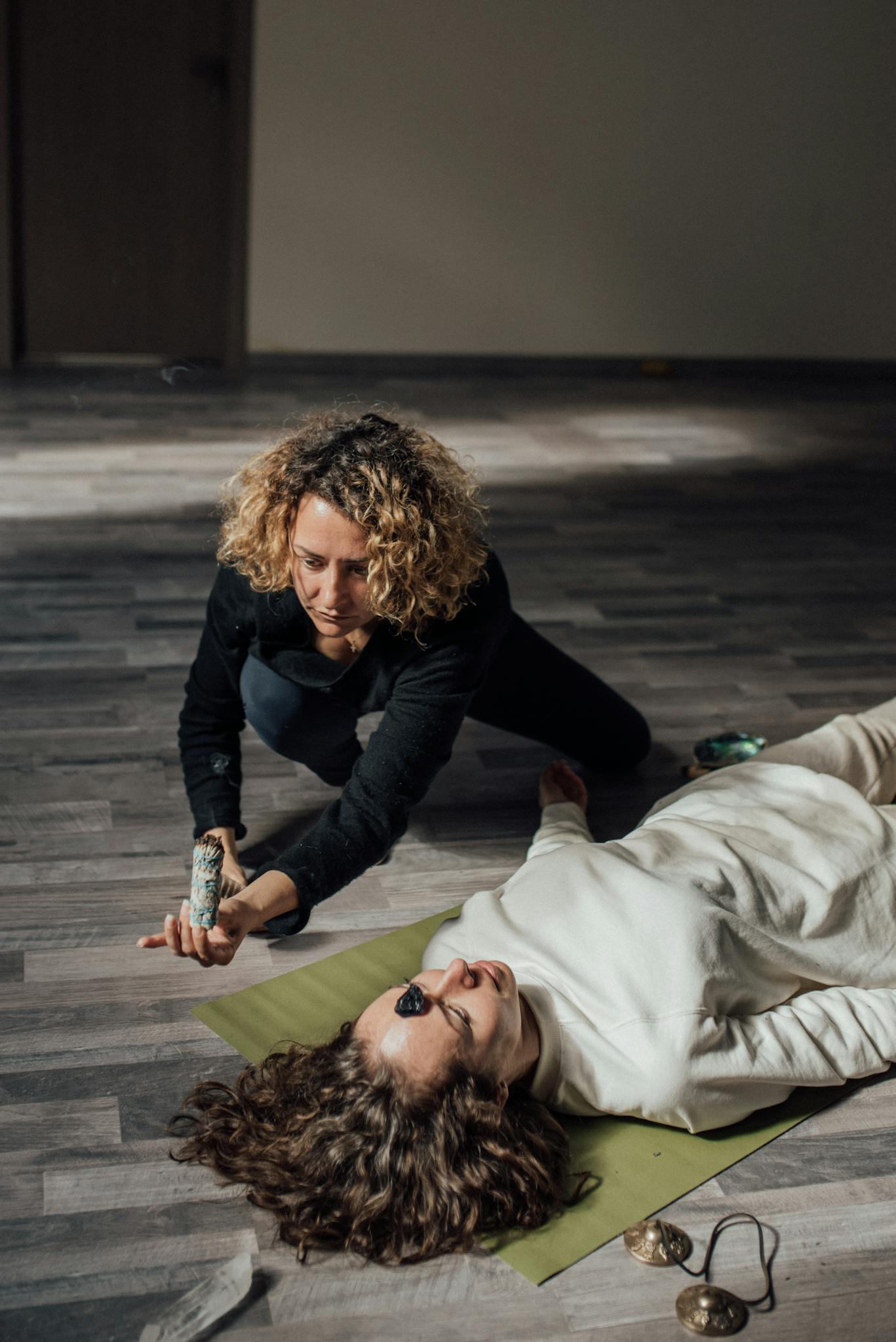 A spiritual healing session indoors with sage cleansing and energy balancing.